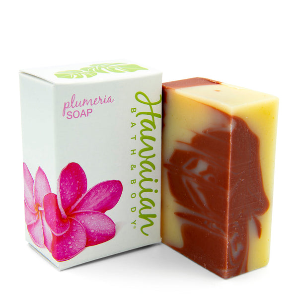 white box with a pink plumeria flower, next to a bar soap with red clay swirls - Hawaiian Bath & Body®