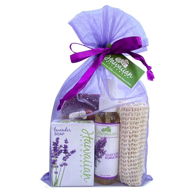 Gift set with lavender-themed products including soap, oil, and a bag in a purple bag with a green tag.
