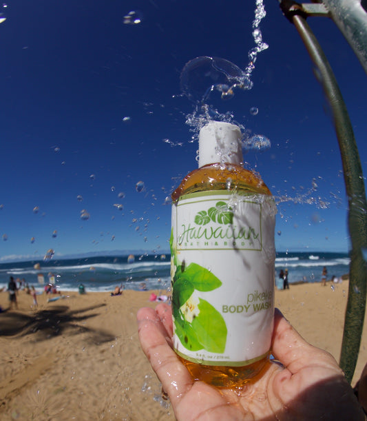 bottle of liquid soap splashed under the water flow of a beach shower head